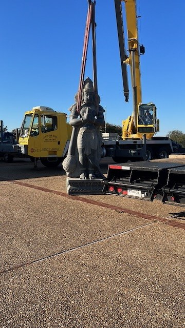 The Hanuman murti being lifted by crane in Denison