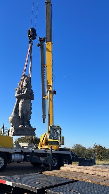 The murti lowered gently onto temple ground